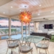 A spacious dining room featuring a sizable glass table surrounded by chairs.