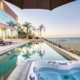 A serene scene of a hot tub and pool beside the mountains, offering a relaxing and picturesque view.