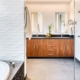 A spacious bathroom featuring a sizable tub and a generously sized mirror.