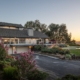 A spacious home with a wide driveway leading up to the entrance.