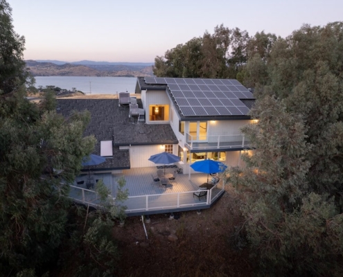 A house with solar panels on the roof, providing sustainable energy for the household.