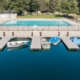 A serene pool with several boats docked, creating a picturesque scene of tranquility and leisure.