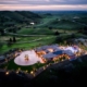 Aerial view of a spacious hilltop mansion surrounded by lush greenery.