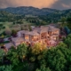 An aerial view of a spacious mountain home surrounded by breathtaking natural scenery.