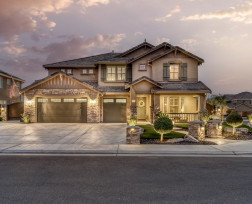 A picturesque home with a driveway leading to a garage.