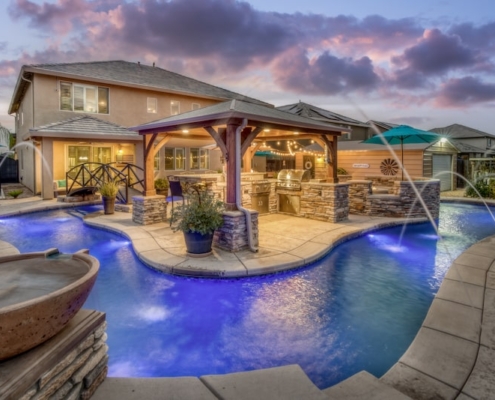 A serene backyard pool with a charming gazebo and a cozy patio area, perfect for relaxation and outdoor gatherings.