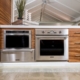 Modern kitchen with stainless steel appliances and wooden cabinets.