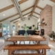 A spacious living room with a brick fireplace as the focal point.