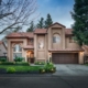 Photo of exterior front view of two story home with well groomed landscaping